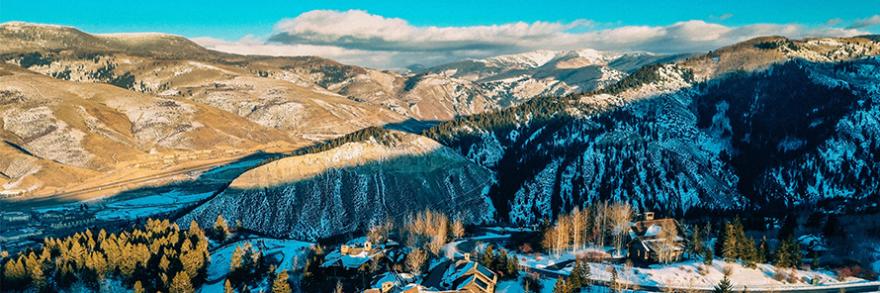Aerial view of lodges and snow-covered mountains during the day in Eagle County, Colorado