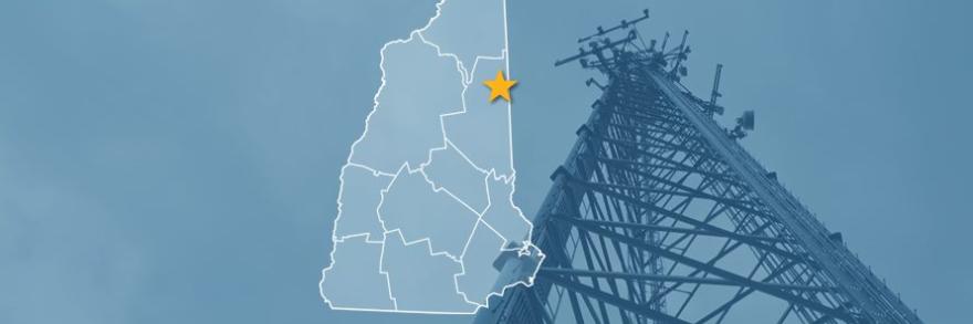 The State of New Hampshire, with outlined county borders and star locating Conway, New Hampshire; a cell tower. 