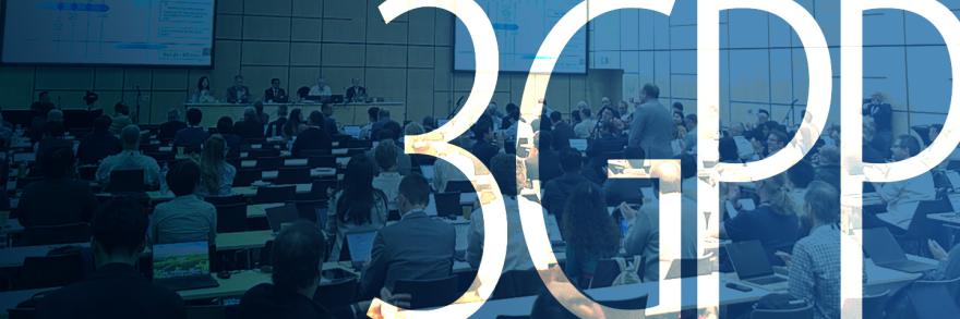 Panel discussion at the June 2025 3GPP meeting with participants seated at conference tables; two large projection screens behind the panel show presentation slides; “3GPP”