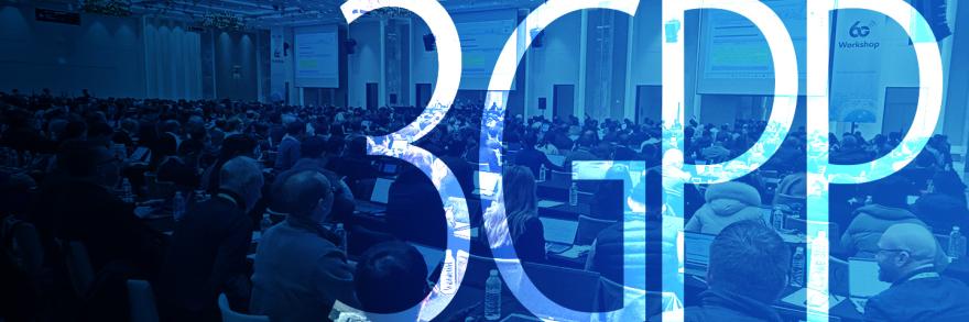 A group of people dressed in business attire taking notes on electronic devices while seated in a large conference room with three oversized presentation screens at the 3GPP 6G workshop; “3GPP”   