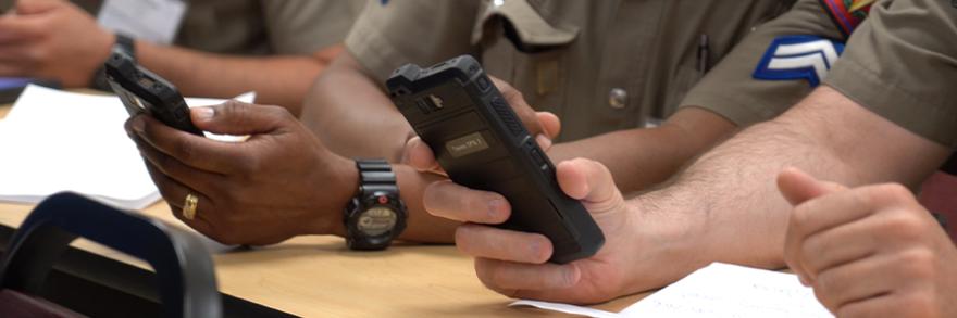 Close view of two FirstNet enabled smartphones held by responders