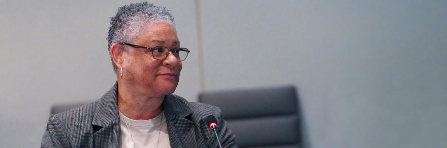 Renee Gordon in front of a microphone at a FirstNet Authority board meeting.