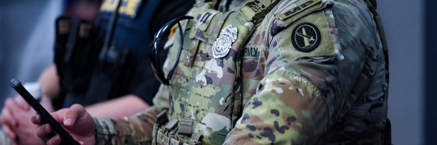 An army military police officer using a FirstNet enabled cell phone