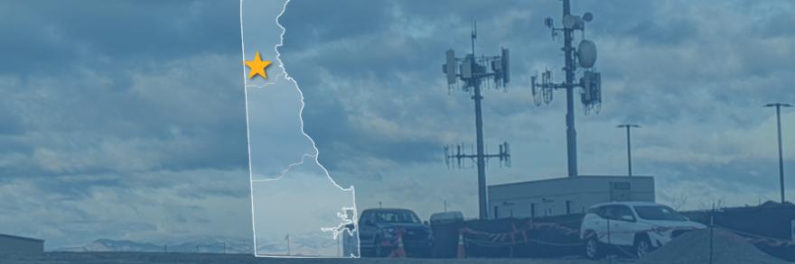 The state of Delaware, with outlined county borders and a star; a cell tower.