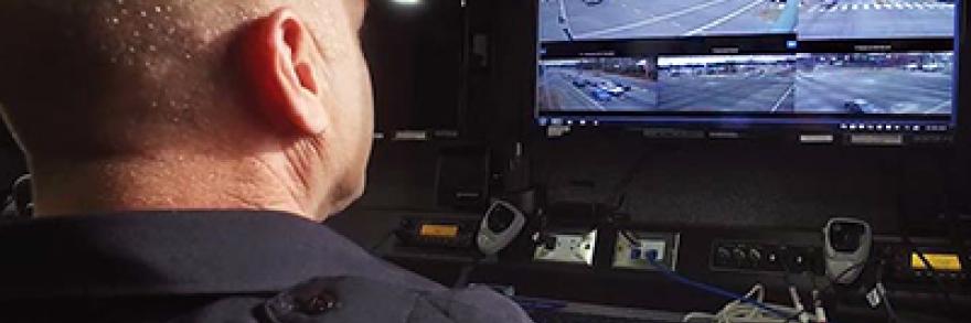 An male officer with the Richmond (Va.) Police Department monitors information n a computer screen.