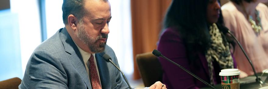 FirstNet Authority Board member Sean McDevitt speaks into a microphone at a board meeting.