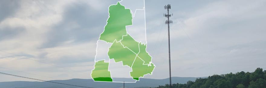 The state of New Hampshire, with outlined county borders; a cell tower.