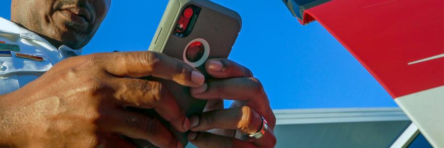 Close up of a smartphone in the hands of a public safety official