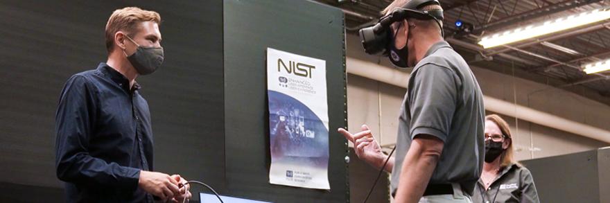 First responder using virtual reality head set inside the Public Safety Immersive Test Center with NIST and FirstNet Authority staff.