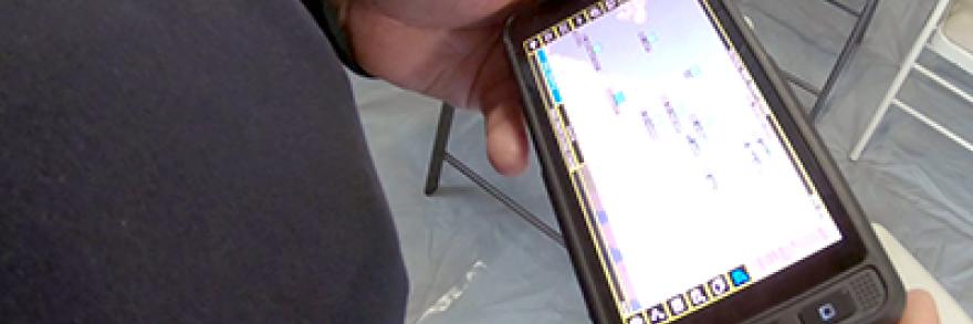 A FirstNet enabled phone held by an officer displaying an app