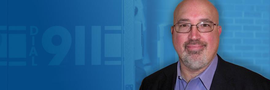 A headshop of Steve Devine, Chief Technology Officer for the Association of Public-Safety Communications Officials International; an ambulance with the message “Dial 911” written on the side.