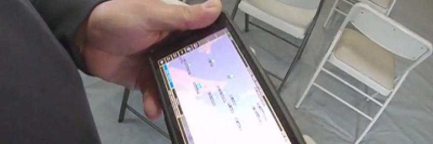 An officers holds a FirstNet device showing a app