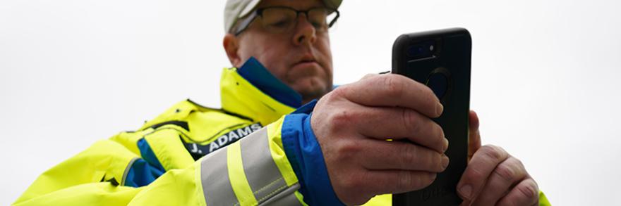 First responder holds smartphone