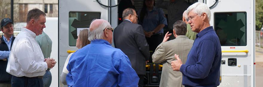 Tip Osterthaler speaks with public safety officials in front of ambulance