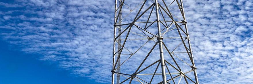 Cell tower with sky in background