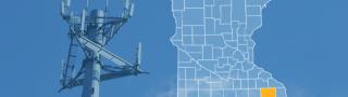 The state of Minnesota, with outlined county borders and Fillmore County highlighted; a cell tower
