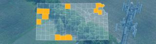 The state of Kansas, with outlined county borders; a cell tower.