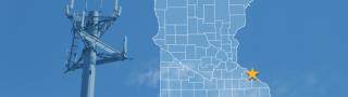 The state of Minnesota, with outlined county borders and a star locating the city of Kellogg; a cell tower