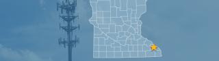 The state of Minnesota, with outlined county borders and a star locating Lewiston, Minnesota; a cell tower.