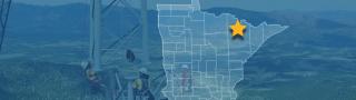 The State of Minnesota, with outlined county borders and a star; a cell tower