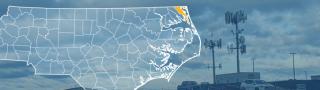 The state of North Carolina, with outlined county borders; a cell tower.
