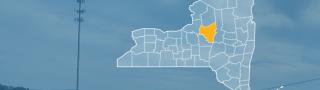 State of New York with counties outlined; highlighting Oneida County, a cell tower