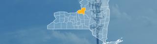 The state of New York, with outlined county borders; a cell tower.