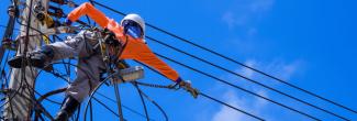 A powerline worker repairing electrical wires