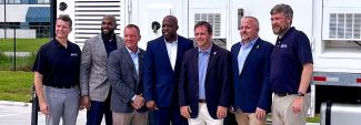 South Carolina public safety leaders, FirstNet Authority and AT&T staff, and U.S. Representative Russell Fry stand in front of a FirstNet SatCOLT