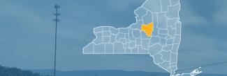 State of New York with counties outlined; highlighting Oneida County, a cell tower