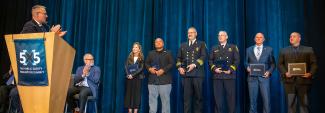 Six 2025 Patriot Award winners stand on stage after receiving their award