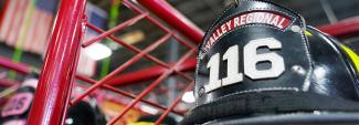 Valley Regional and Fire helmet on display in front of American flags