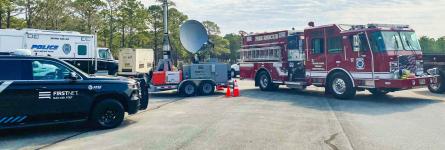 A FirstNet Compact Rapid Deployable and FirstNet, Fire &amp; Rescue, and Police vehicles parked at Military Ocean Terminal Sunny Point, North Carolina
