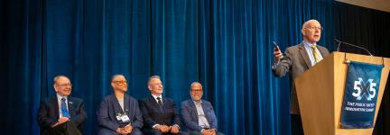 Bill Schrier speaks on stage after receiving the McEwen Award 