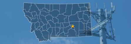 The state of Montana, with outlined county borders and a star locating cell site; a cell tower.