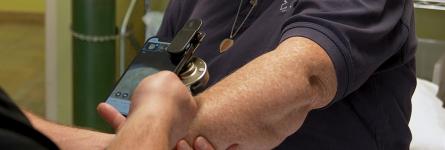 Jackman paramedic using a telemedicine application on a FirstNet-enabled smartphone while tending to a patient